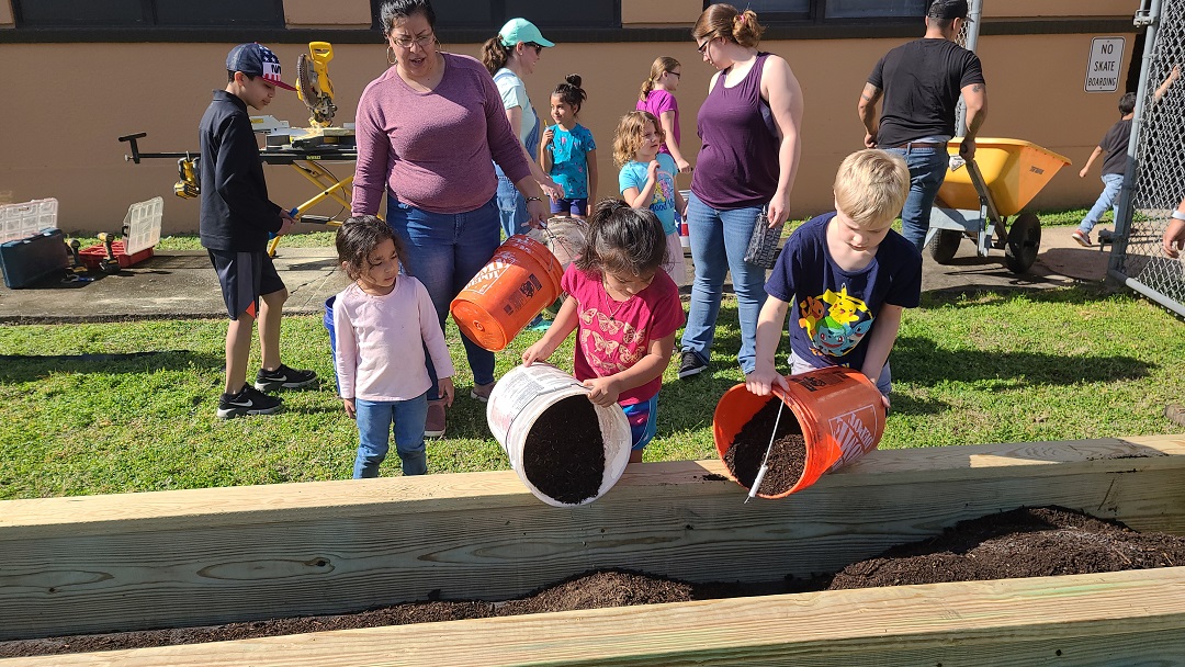 Children planting  at CLI